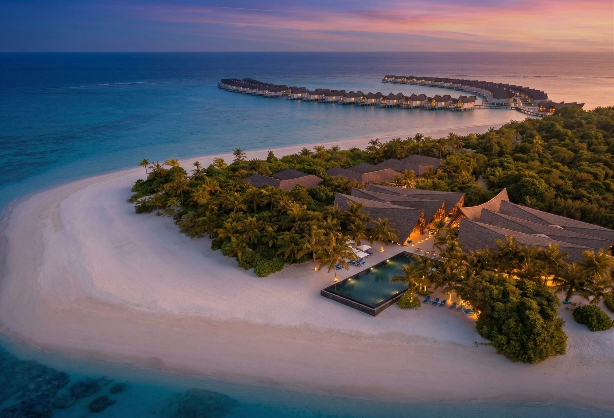 Kuredhivaru Resort — drone aerial of the resort spit at sunset, Maldives