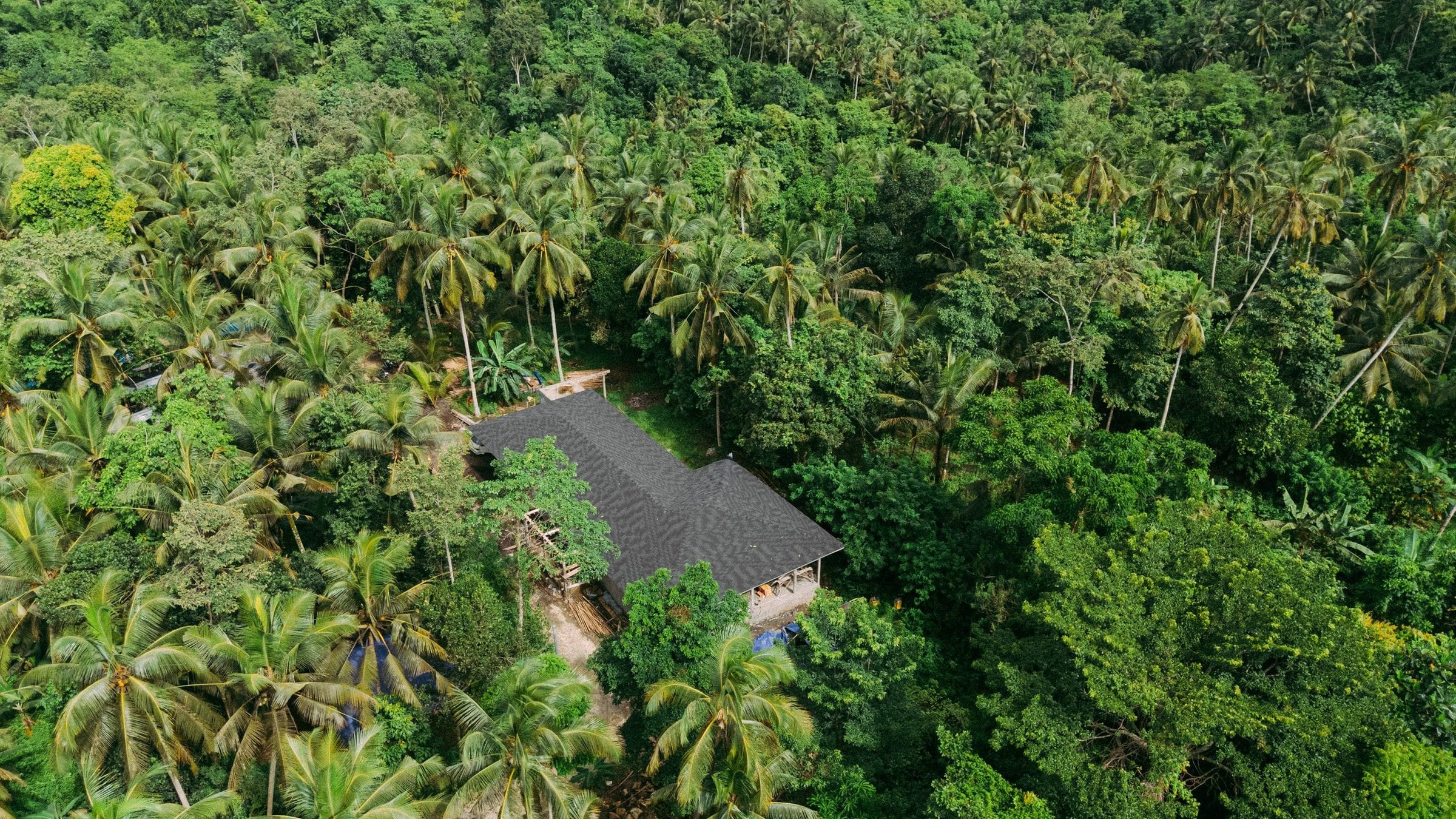 Drone view of a Nirvana Islands build embedded in dense Bali jungle