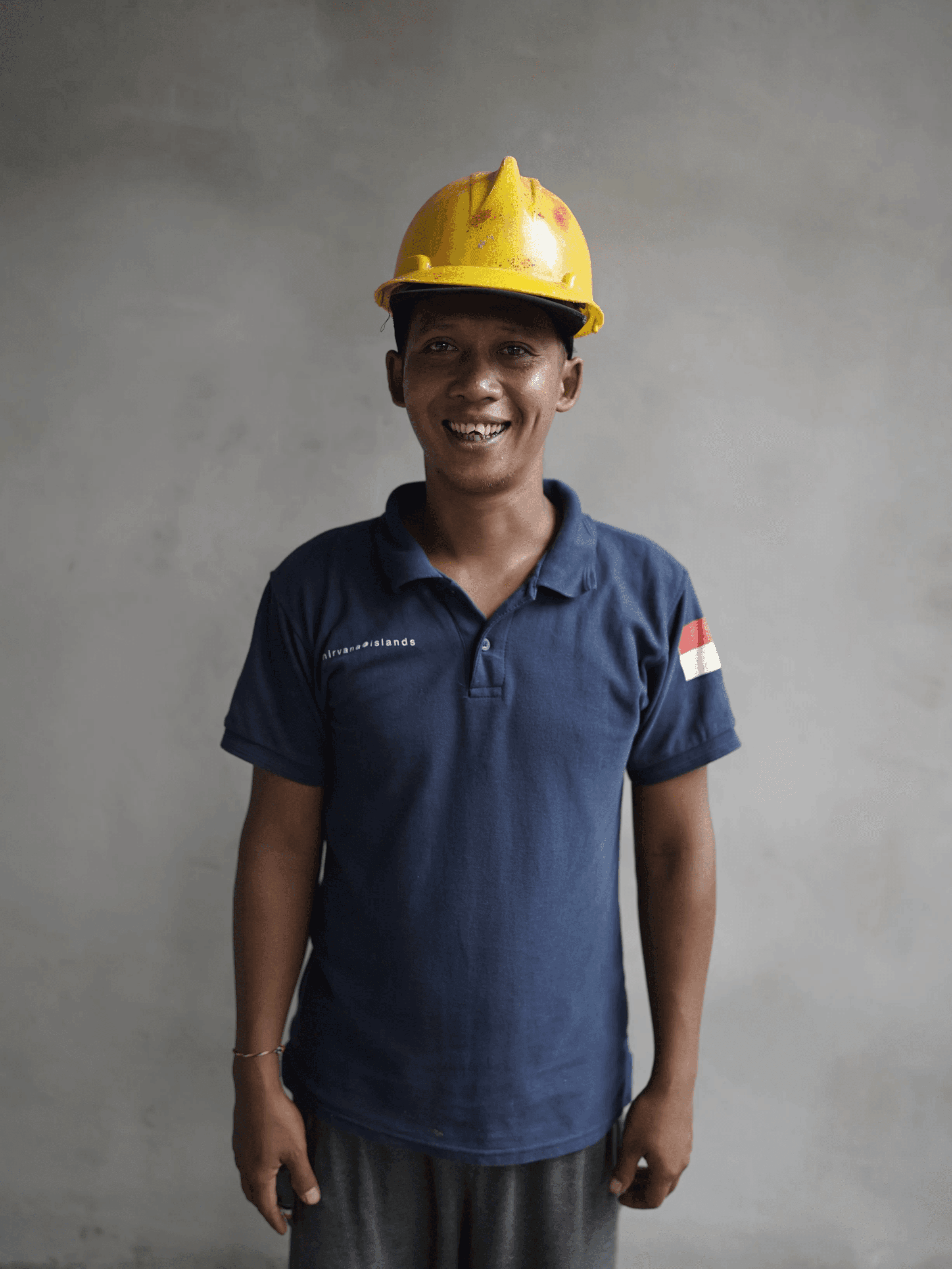 Member of the Nirvana Islands site team in branded polo and yellow hardhat
