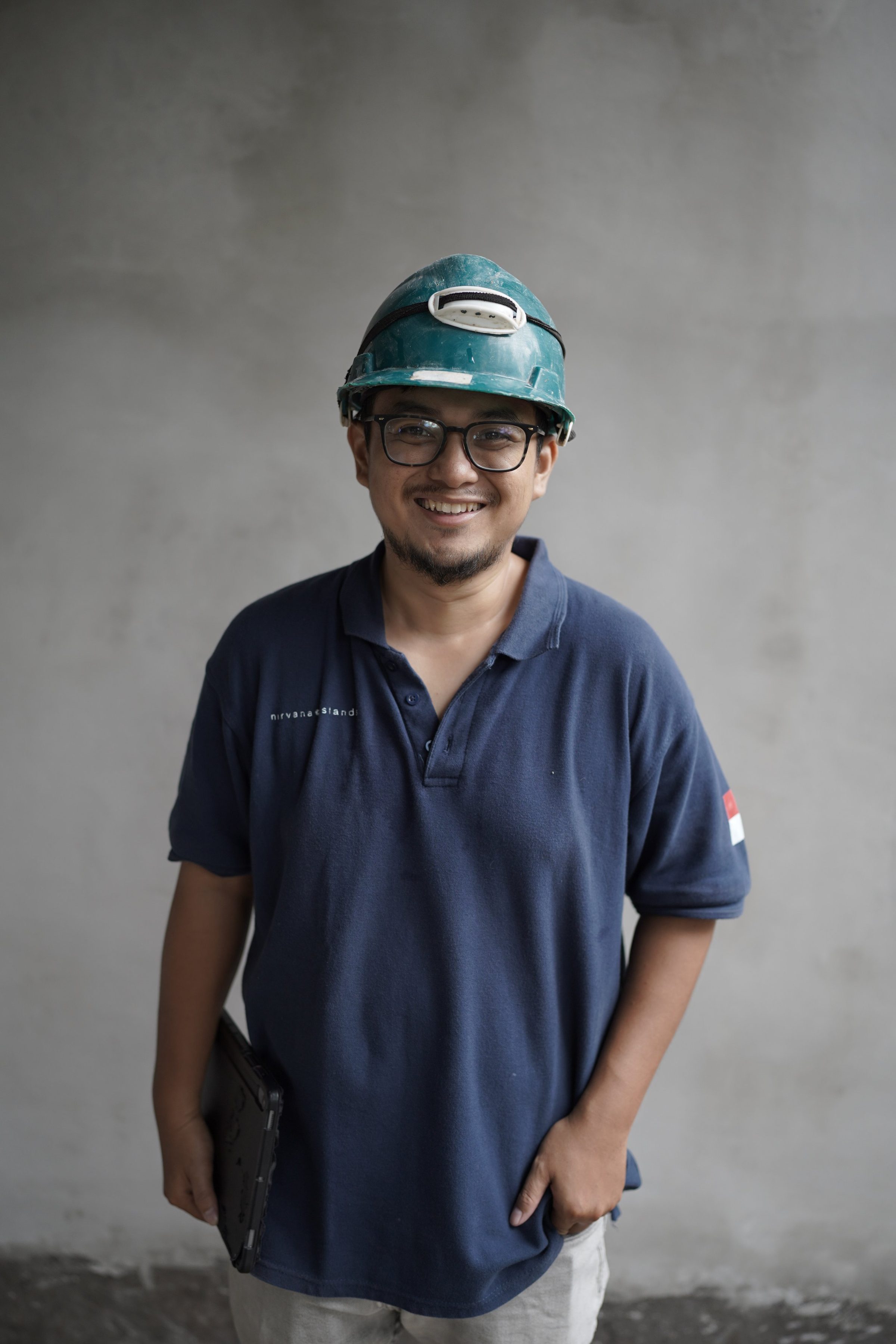 Member of the Nirvana Islands site team in branded polo and hardhat
